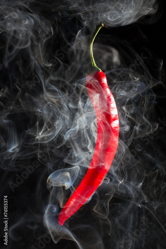Smoking red hot chili Pepper on a black background