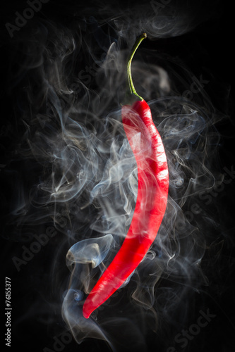 Smoking red hot chili Pepper on a black background