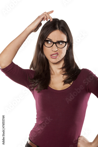 nervous young woman scratching her head