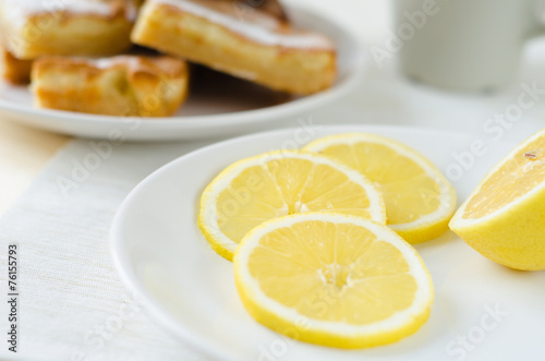 slices of lemon a white plate on table