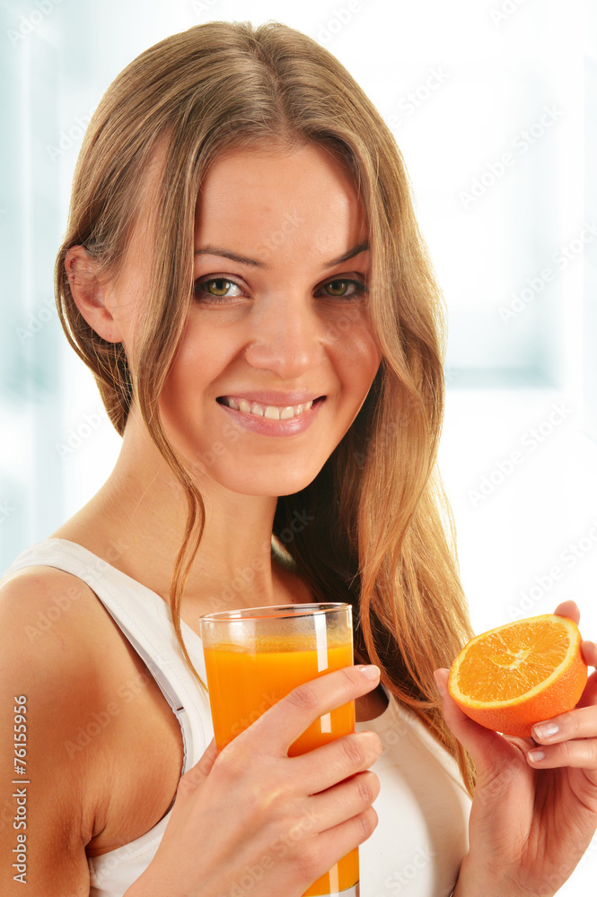 Young woman holding glass of orange juice Young woman holding glass of orange juice