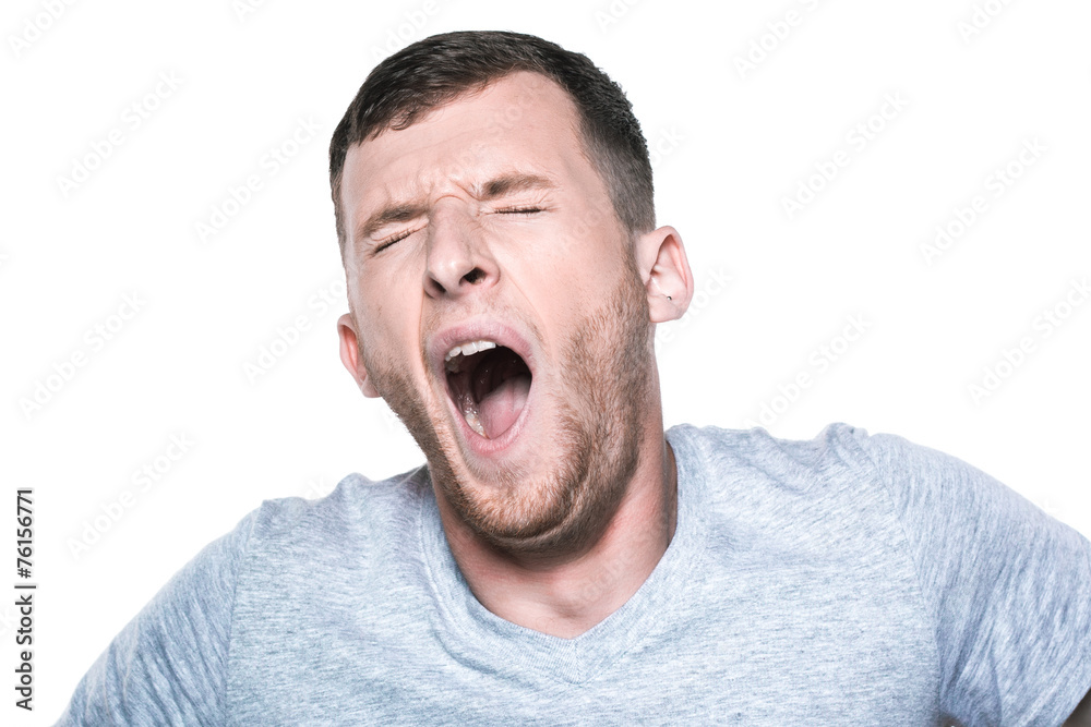Tired sleepy young man yawning