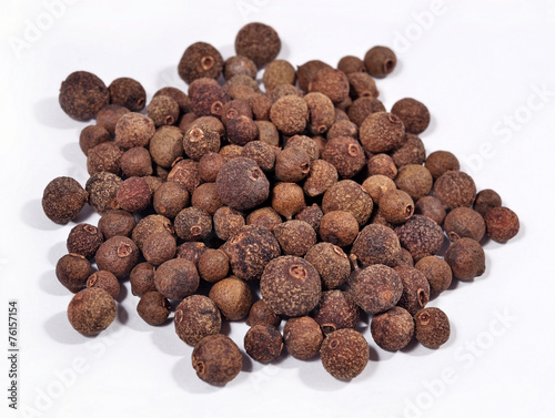 Heap of allspice on a white
