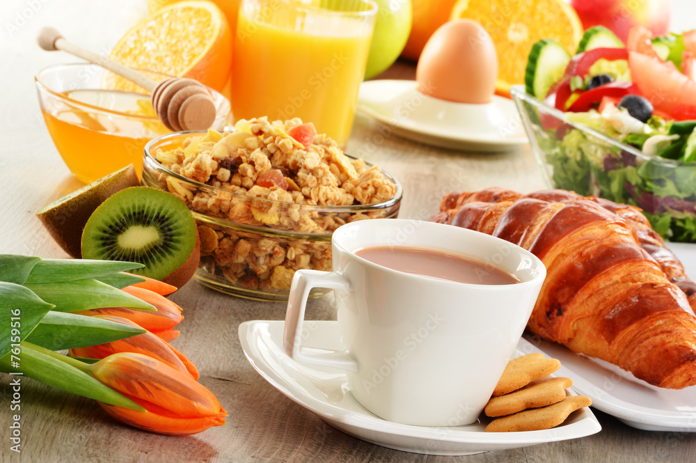Breakfast with coffee, juice, croissant, salad, muesli and egg Breakfast with coffee, juice, croissant, salad, muesli and egg