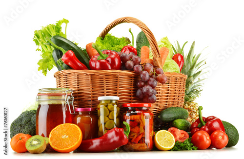 Wicker basket with groceries isolated on white
