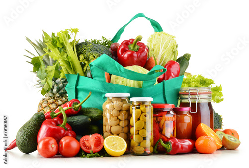 Green shopping bag with groceries isolated on white