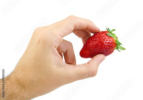 Hand holding a strawberry isolated on white.