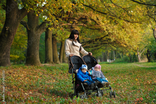 mother with children twins on a walk in the autumn park © lisovoy