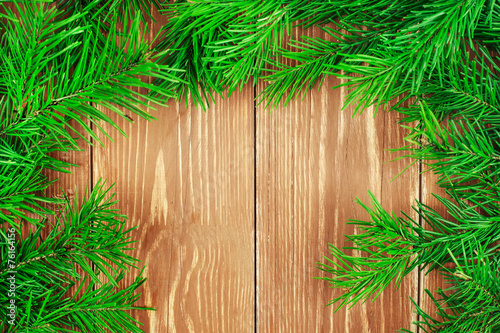 Fir branches on wooden table. Copyspace background.
