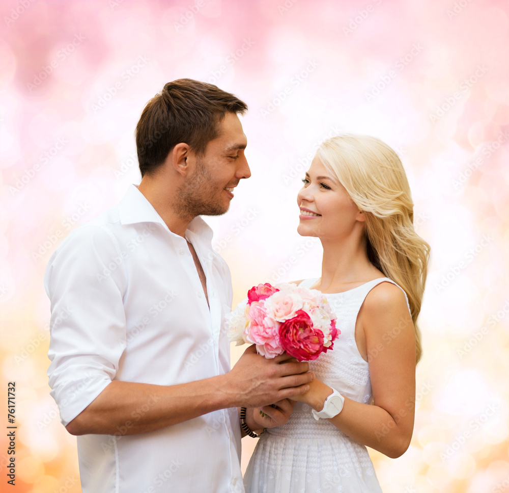 happy couple with flowers over lights background happy couple with flowers over lights background