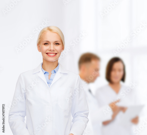 smiling female doctor with group of medics