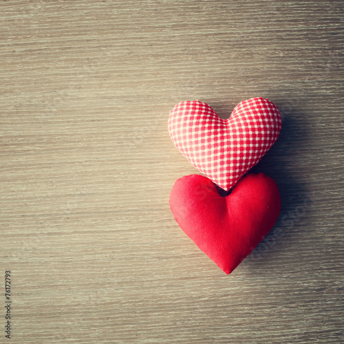 Red stuffed hearts over wood