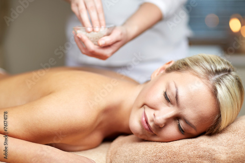 close up of woman lying and having massage in spa