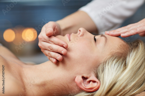 close up of woman having face massage in spa