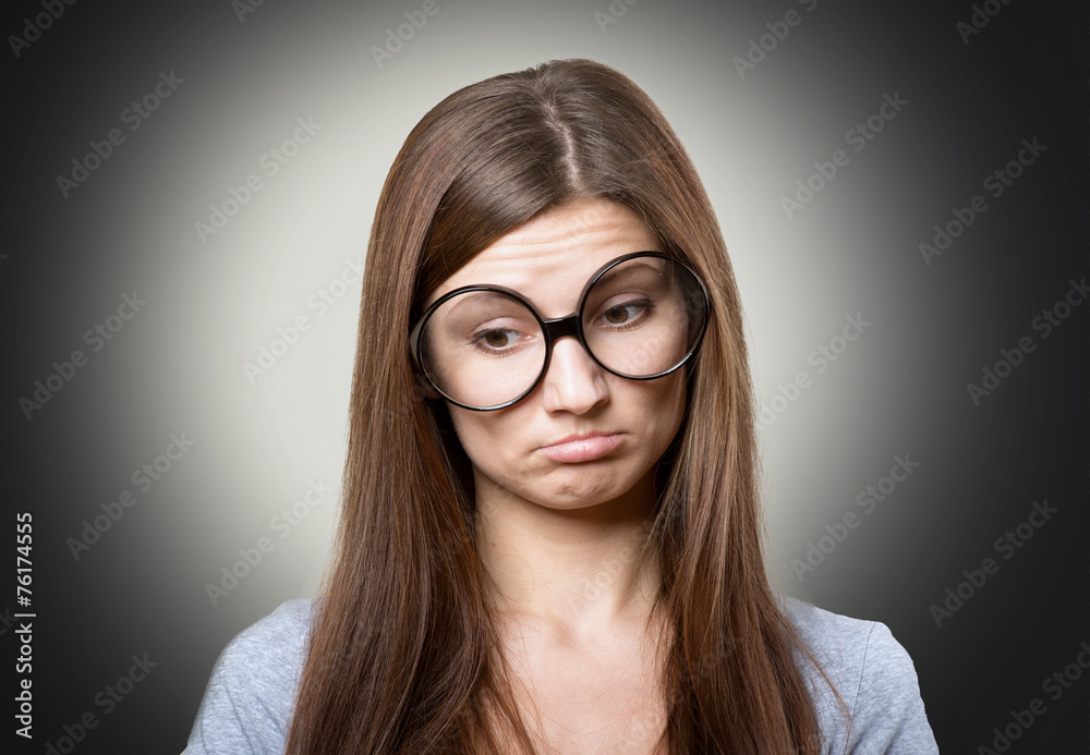 Funny pensive girl in large glasses