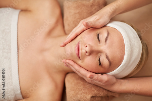 close up of young woman having face massage in spa
