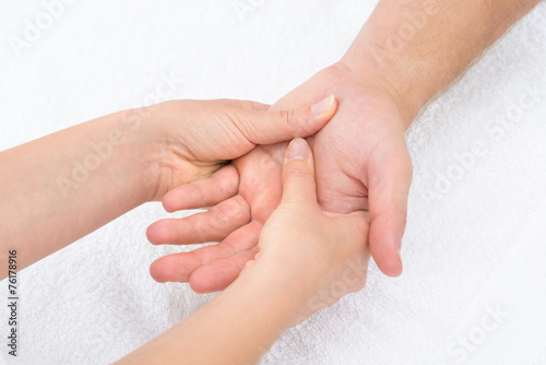 Physiotherapist Massaging Palm
