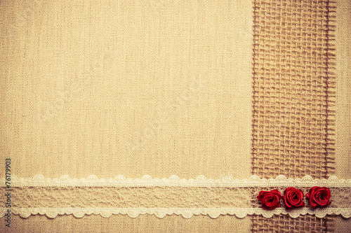 Frame of red silk roses on cloth