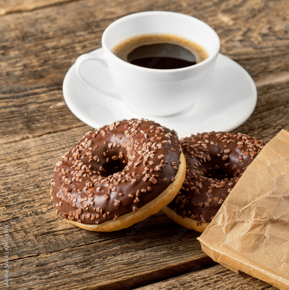 Overhead view of two tempting fresh doughnuts with their brown p Overhead view of two tempting fresh doughnuts with their brown p