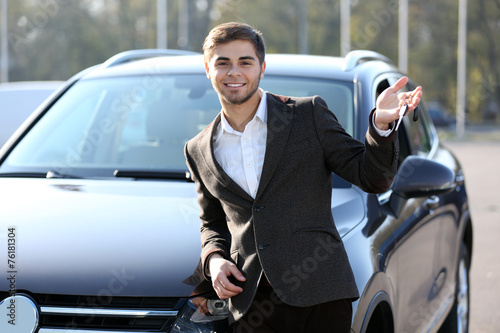 Businessman holding car key...