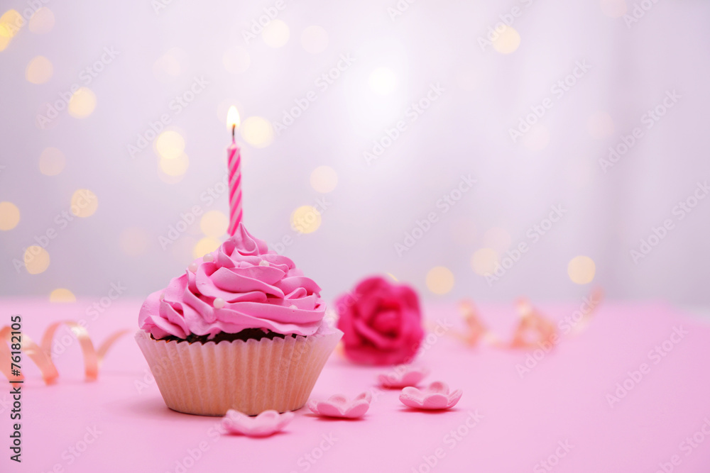 Delicious birthday cupcake on table on light background Delicious birthday cupcake on table on light background