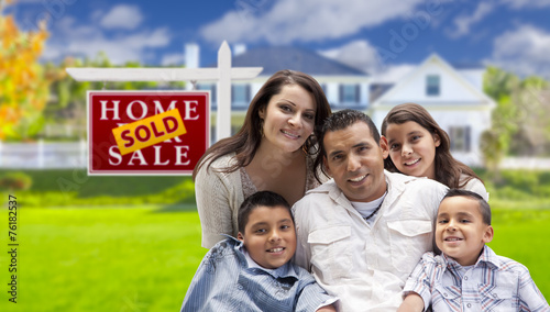 Hispanic Family in Front of Sold Real Estate Sign, House