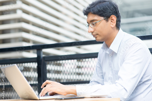 Indian businessman using laptop © WONG SZE FEI