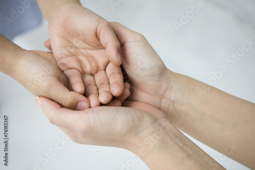 Overlapping hands of women and children