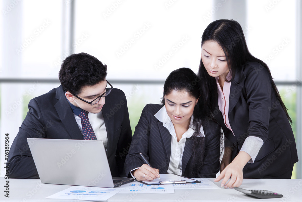 Female manager signing a document Female manager signing a document