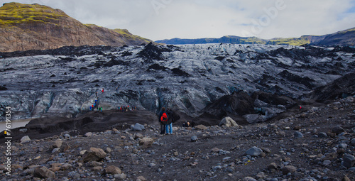 Iceland Glacier with a group of hikers hiking tourists climbing