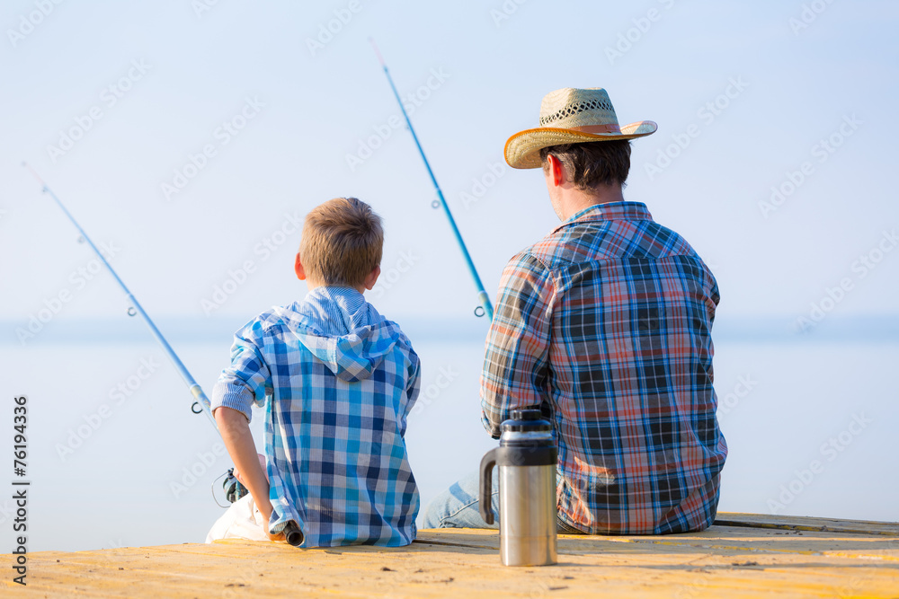 boy and his father fishing togethe boy and his father fishing togethe