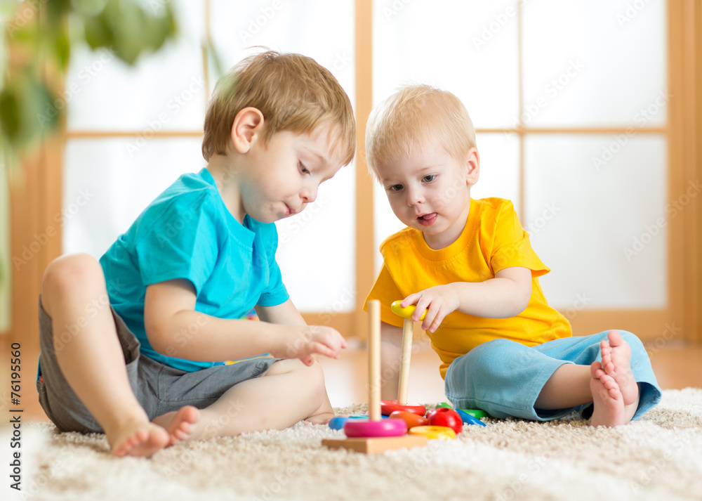 children boys with toys in playroom children boys with toys in playroom