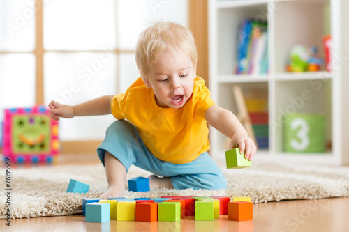 kid boy playing wooden toys