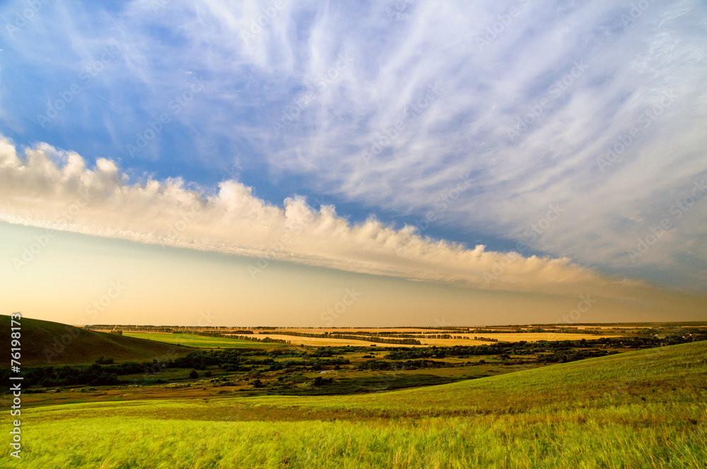 Fototapeta premium Sky with clouds in hilly countryside in sunset or sunrise time