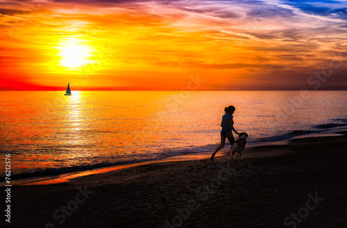 Girl with dog on the beach