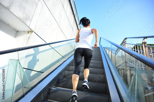 Runner athlete running on escalator stairs. 