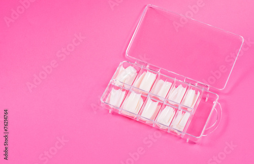 Fake nails in case on pink background