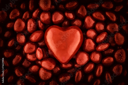 A Big Candy Heart on top of Small Valentine Candies