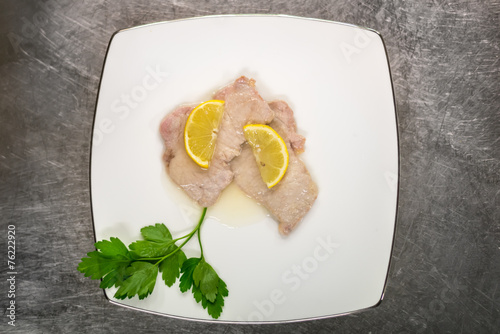 Top view of plate with lemon escalop