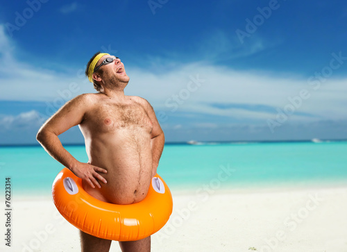 Strange naked man on the beach