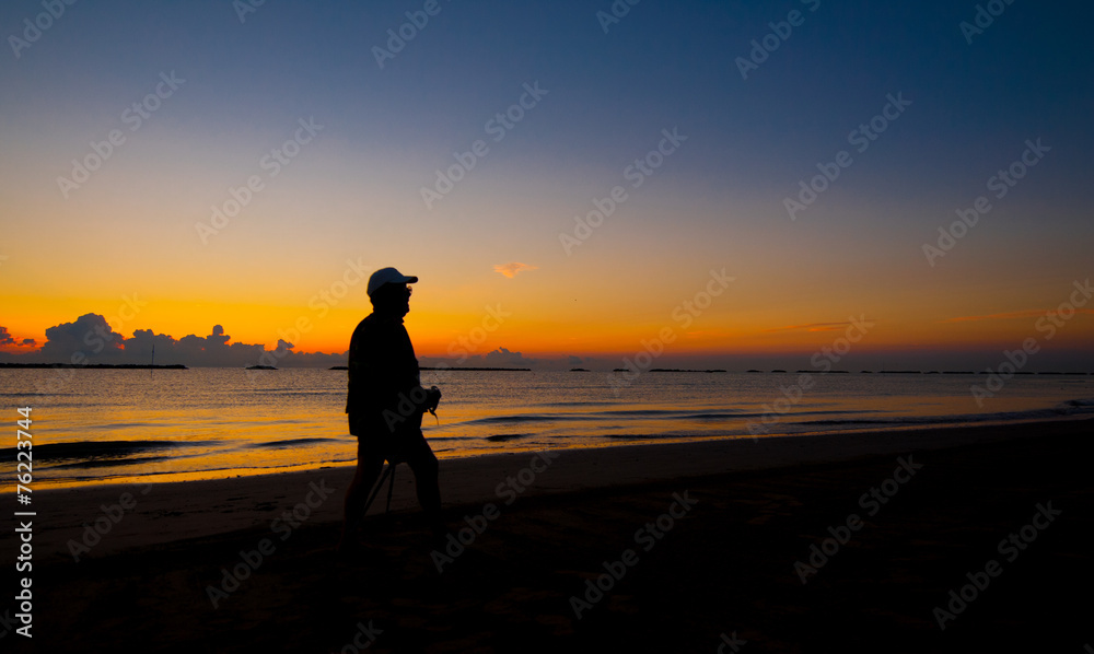 silhouette of a man walking on the sea