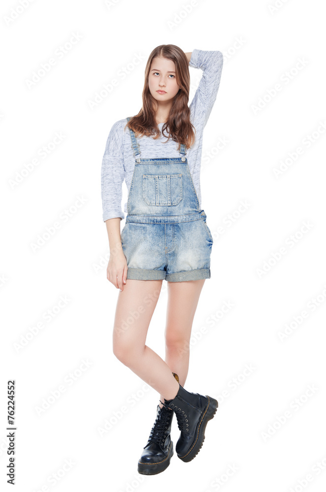 Young fashion girl in jeans overalls posing isolated Young fashion girl in jeans overalls posing isolated
