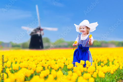 Beautiful dutch girl in tulip field in Holland
