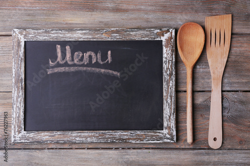 Blackboard menu on rustic wooden planks background