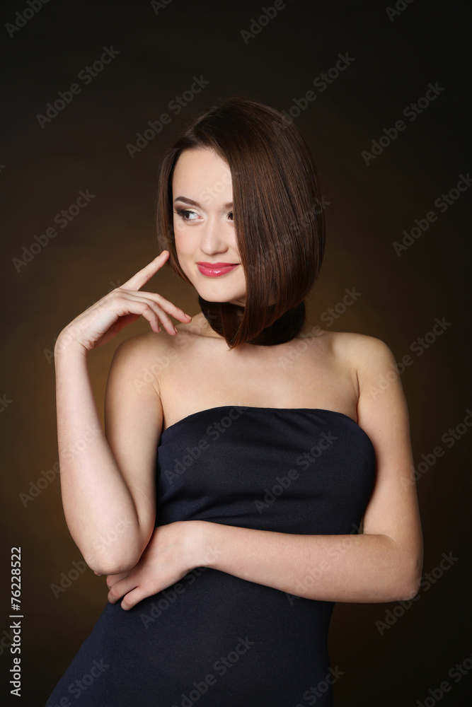 Beautiful young woman with long hair on dark brown background Beautiful young woman with long hair on dark brown background