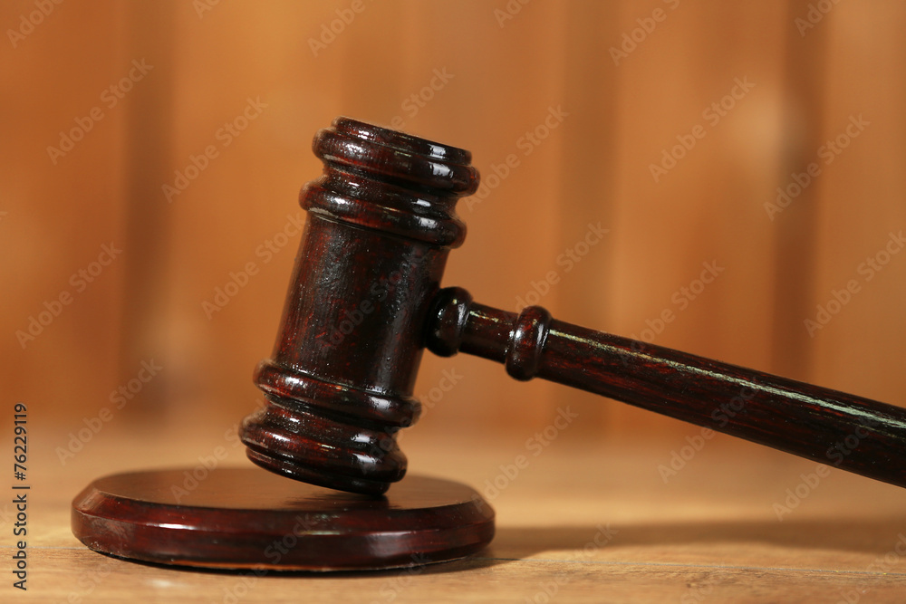 Wooden judges gavel on wooden table, close up Wooden judges gavel on wooden table, close up