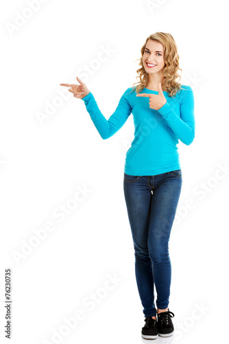 Woman pointing on copy space.