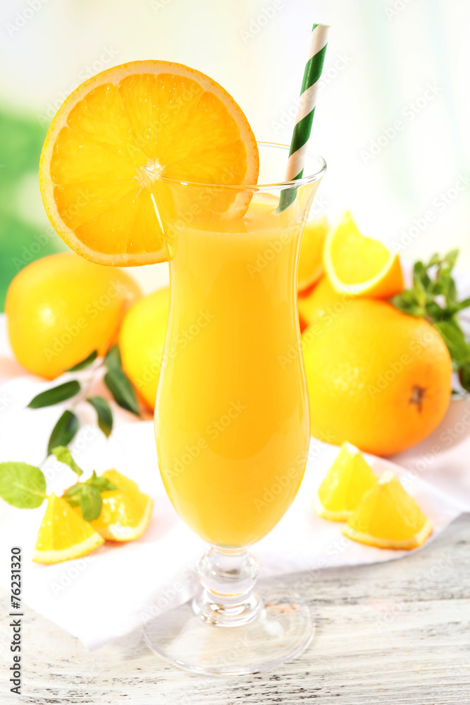 Glass of orange juice with straw and slices Glass of orange juice with straw and slices