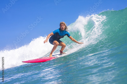 Surfer girl on the wave, Indonesia. © trubavink