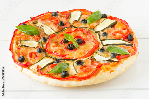 italian pizza with black olives, cherry tomatoes, eggplants and